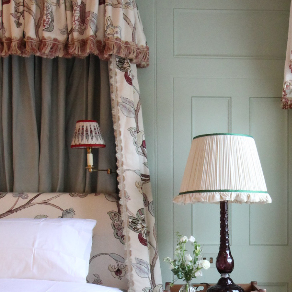 Close up view of a bright bedroom with a lovely textured headboard and bed
